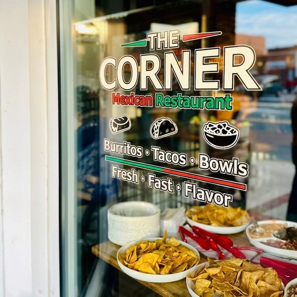 The Corner Mexican Restaurant storefront window with menu items and tortilla chips on display.